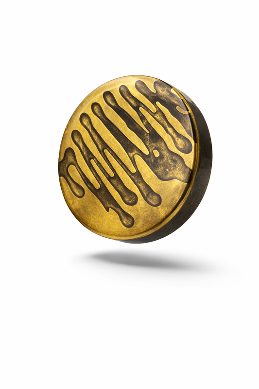 Gold and black decorative object on a white background